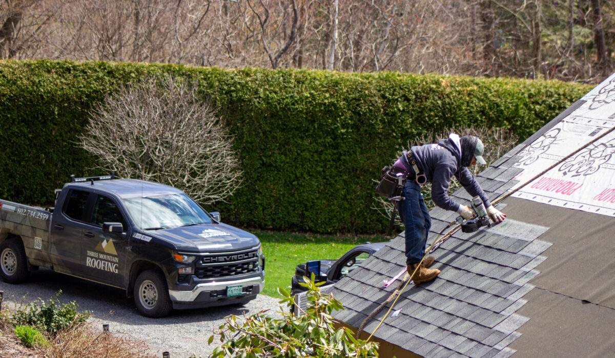 Roofing contractor in Vermont performing spring roof maintenance.