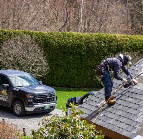 Roofing contractor in Vermont performing spring roof maintenance.