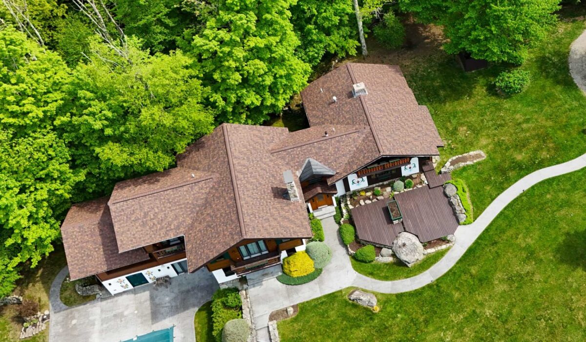 Asphalt shingles roofing material on large home vs other roofing types.