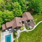 Asphalt shingles roofing material on large home vs other roofing types.