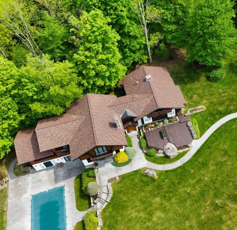 Asphalt shingles roofing material on large home vs other roofing types.