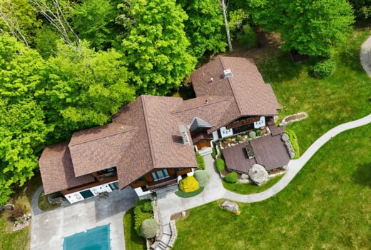 Asphalt shingles roofing material on large home vs other roofing types.