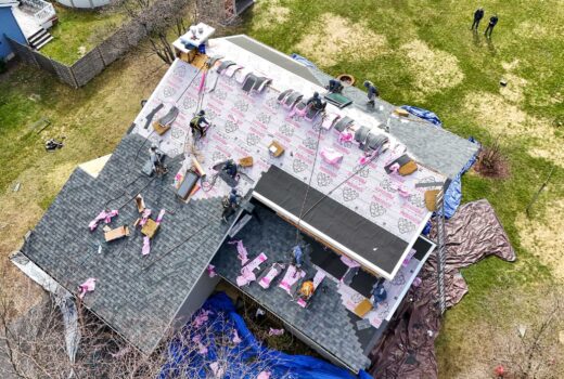 Roofing contractors putting roofing underlayment in place for roof protection.