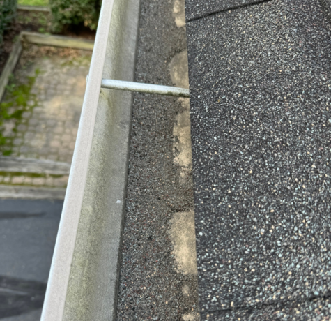 Asphalt shingle granule loss in the gutters.