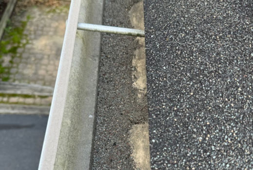 Asphalt shingle granule loss in the gutters.