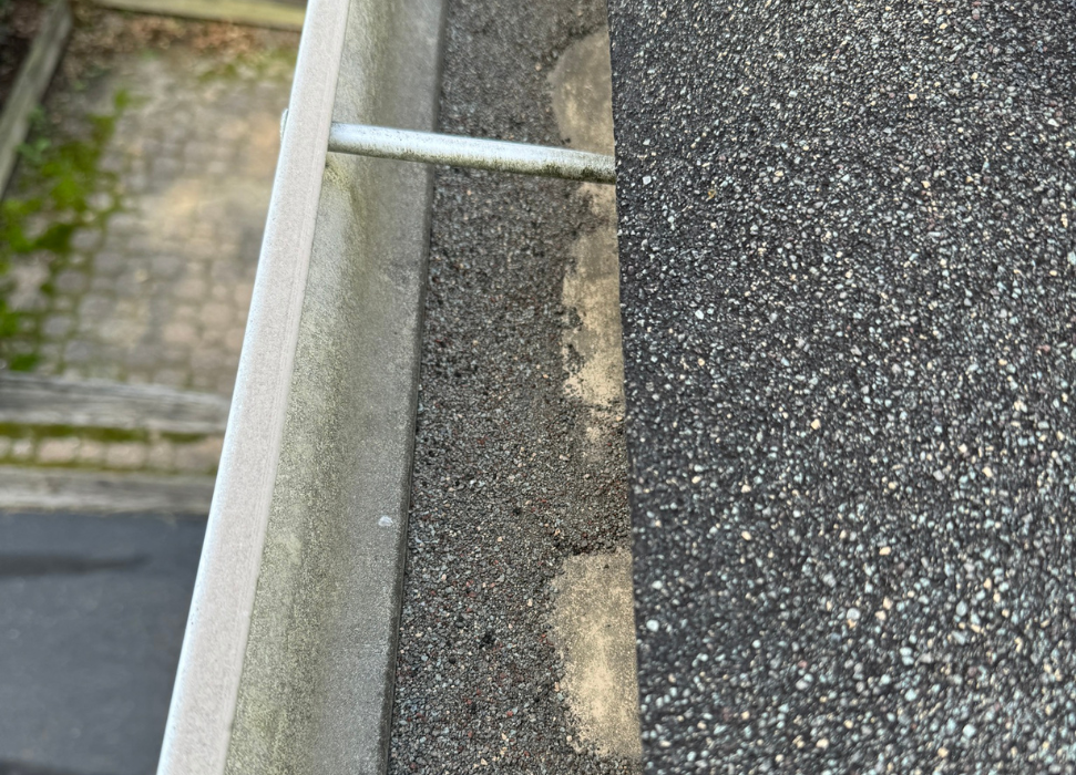 Asphalt shingle granule loss in the gutters.