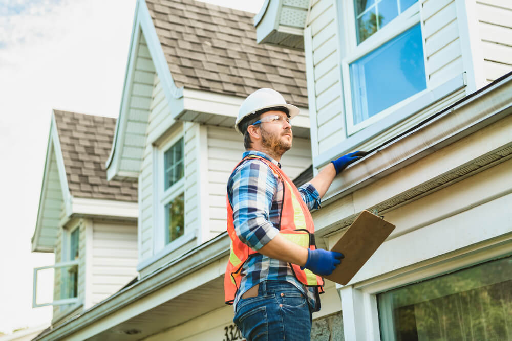 local roofing expert conducts roof inspection